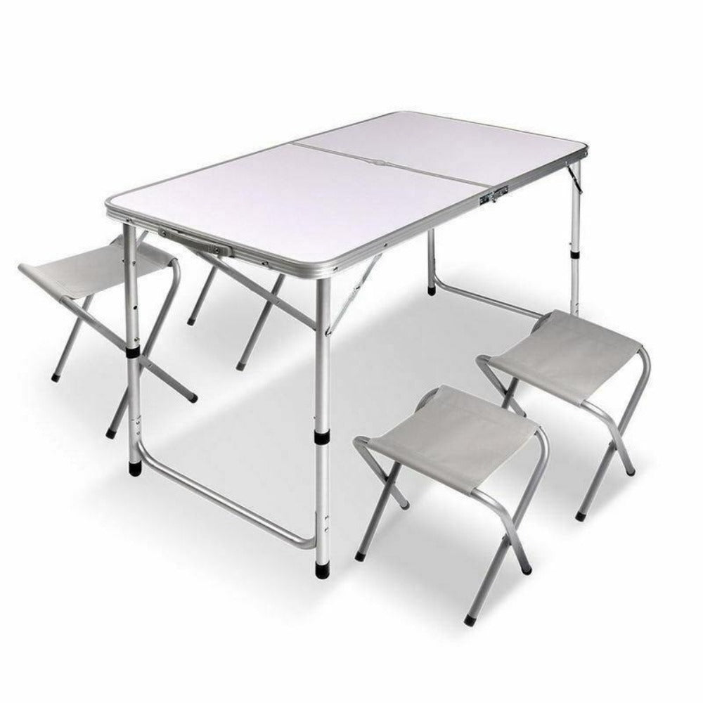 A portable aluminium folding picnic table with four matching chairs set up, all in a metallic color.