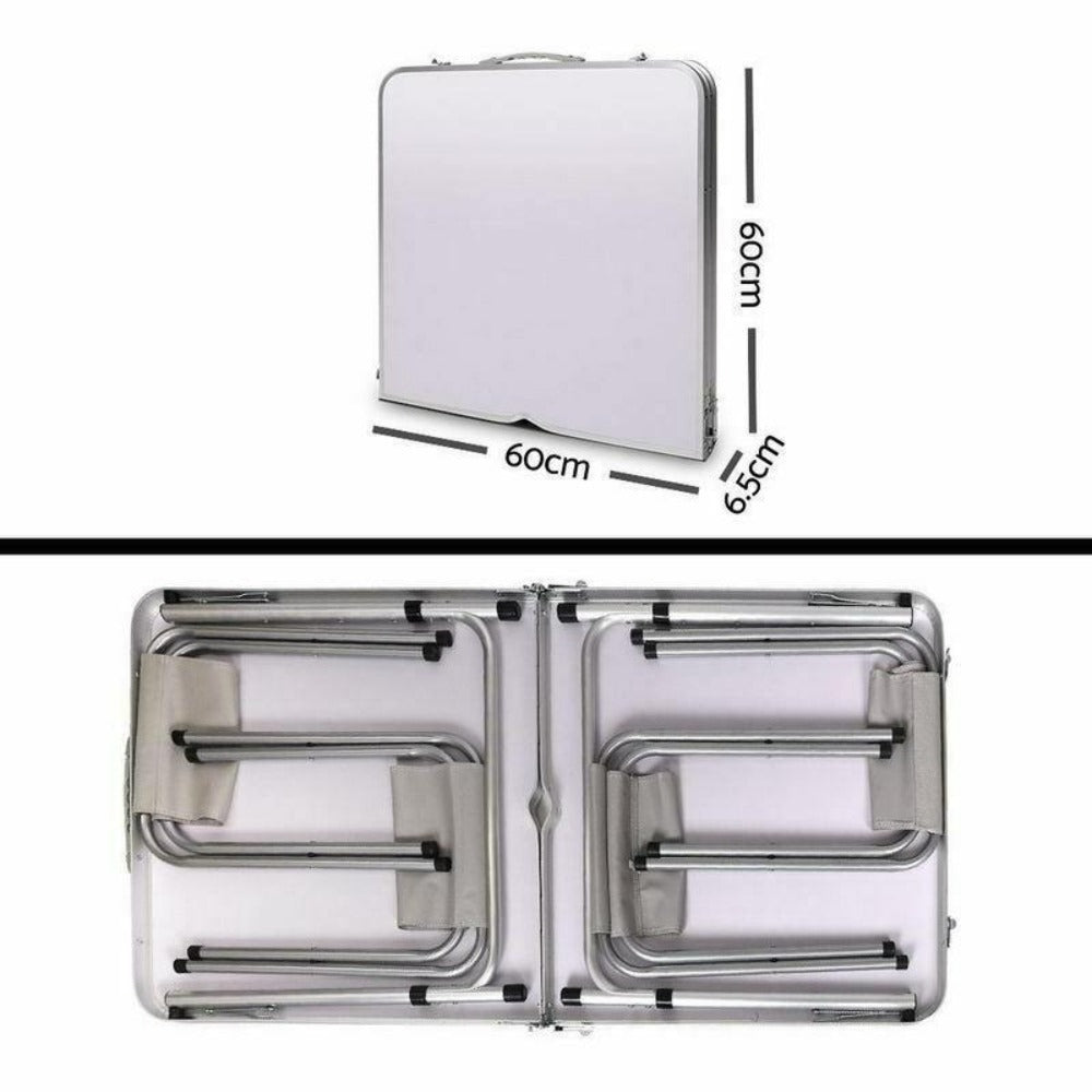 A portable aluminium folding picnic table folded up.