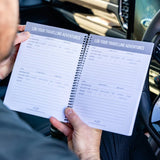 Inside pages of the Adventure Awaits Australian-made Caravan and Camper Log Book showing destination, kilometres, accommodation type, rating and notes entry fields