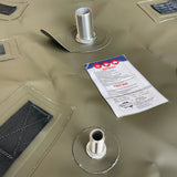 Close-up of Fleximake fuel bladder showing stainless steel inlet and outlet fittings with reinforced mounting points
