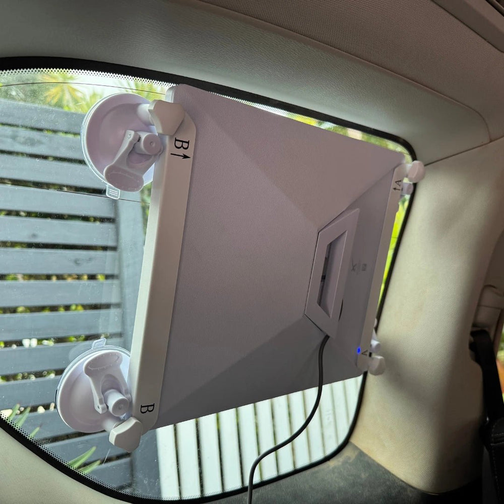 Starlink Mini attached to rear vehicle window using a heavy-duty suction mount bracket for temporary portable internet