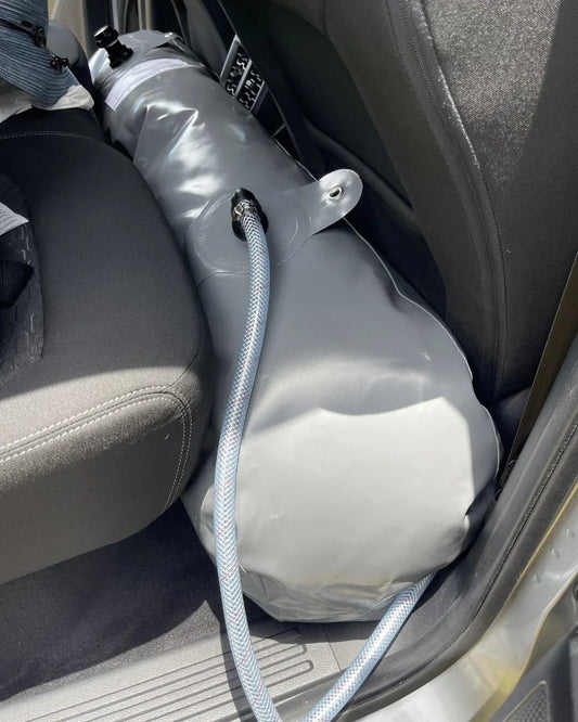 water bladder fitted across the rear footwell of a 4WD for flexible touring water storage