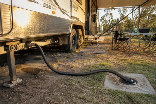 sullage hose running from a caravan grey water outlet to a park drain