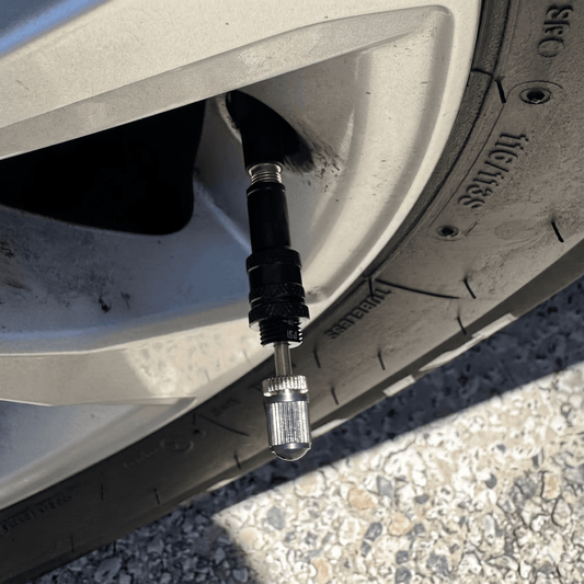 Tyre deflator screwed onto a valve stem ready to air down a 4WD tyre