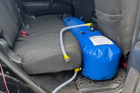 Fleximake water bladder set up in a vehicle footwell for camping water storage and caravan tank filling