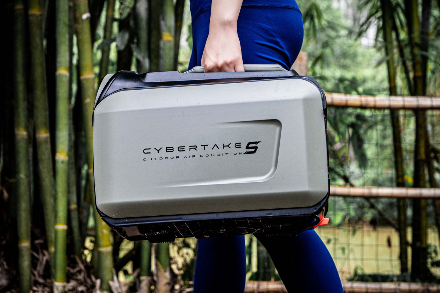 Person holding a Cybertake outdoor air conditioner