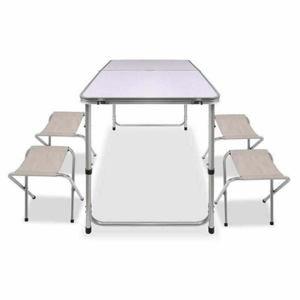 A portable aluminium folding picnic table with four matching chairs set up, all in a metallic color.