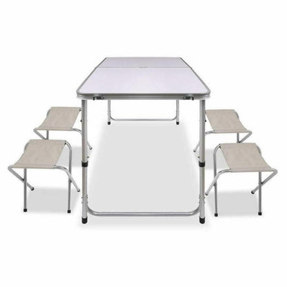 A portable aluminium folding picnic table with four matching chairs set up, all in a metallic color.