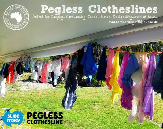 Adventure Awaits Slide n' Dry rainbow pegless clothesline in use under a caravan awning outdoors with a full load of colourful clothing hanging without pegs