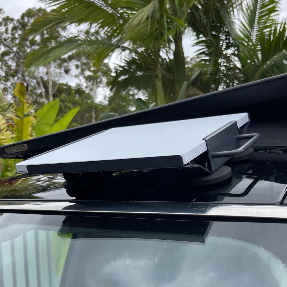 Low profile side view of Starlink Mini on magnetic roof mount showing stable fit and ground clearance